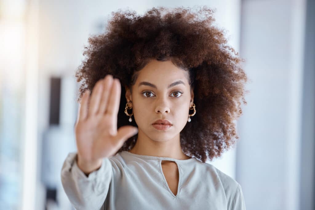 Hands, hr and manager stop sign with hand in office, representing the prevention of sexual harassment in multifamily communities
