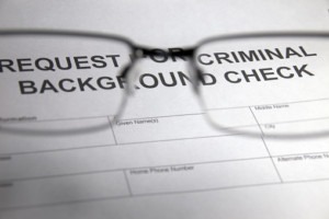 closeup of criminal background check and eyeglasses