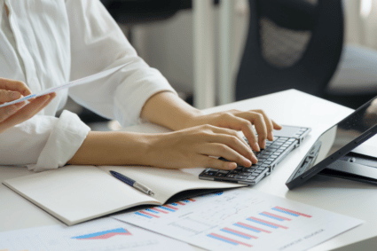 Business woman at desk analyzing graphs