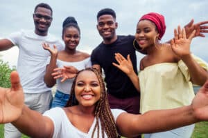 Juneteenth Blog group of five friends female and male taking selfie on camera sm