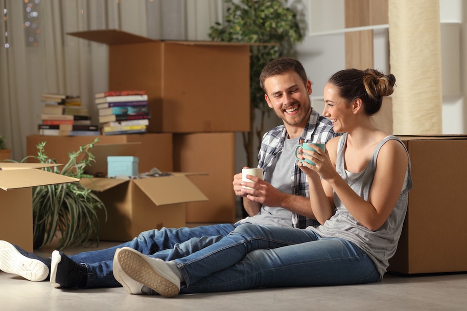 Resident Safety Happy couple moving home resting and talking
