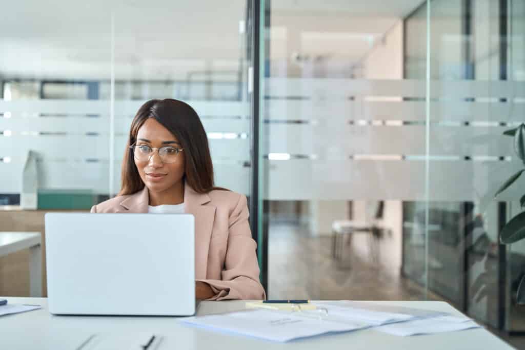 Professional business woman employee working on computer in office.