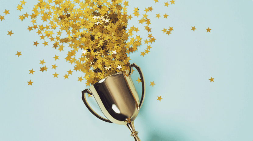 trophy with gold confetti shooting out of it