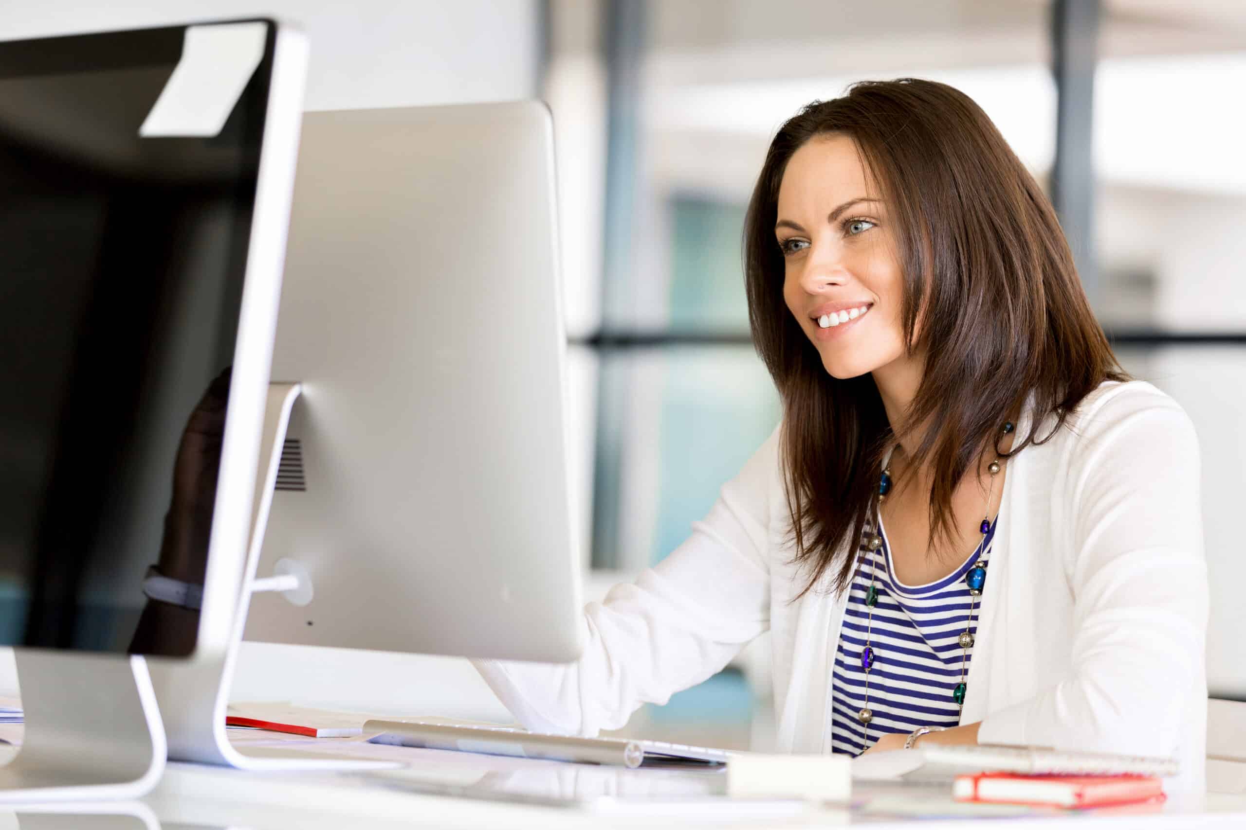 Portrait of businesswoman completing employee onboarding on desktop