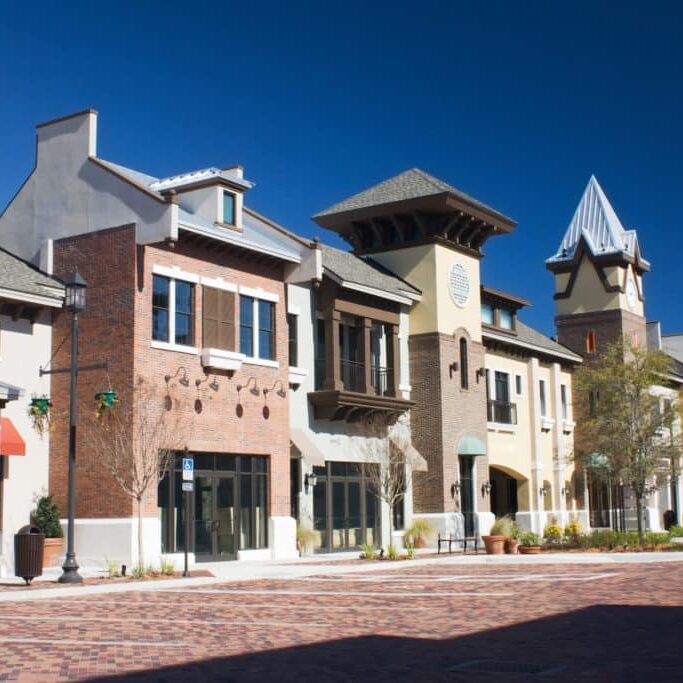 mixed architecture styles commercial strip mall with brick paver parking