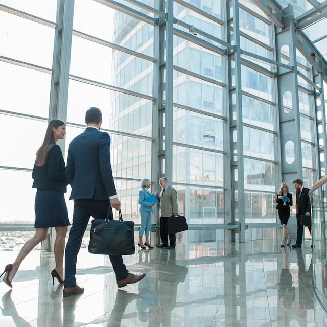 tenants walking in glass building that is under commercial property management