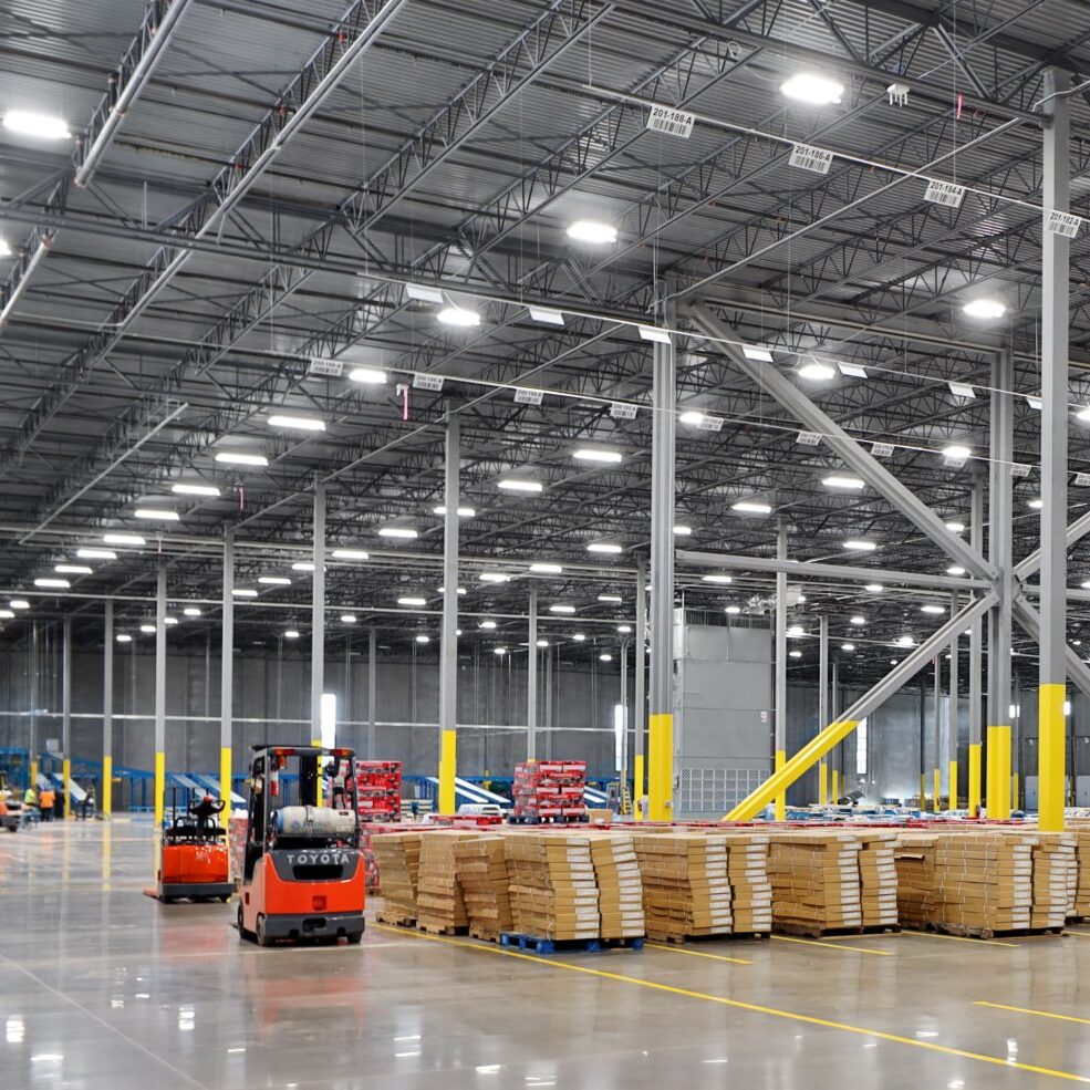 Interior of large warehouse industrial building with parked fork Interior of large warehouse industrial building with parked fork
