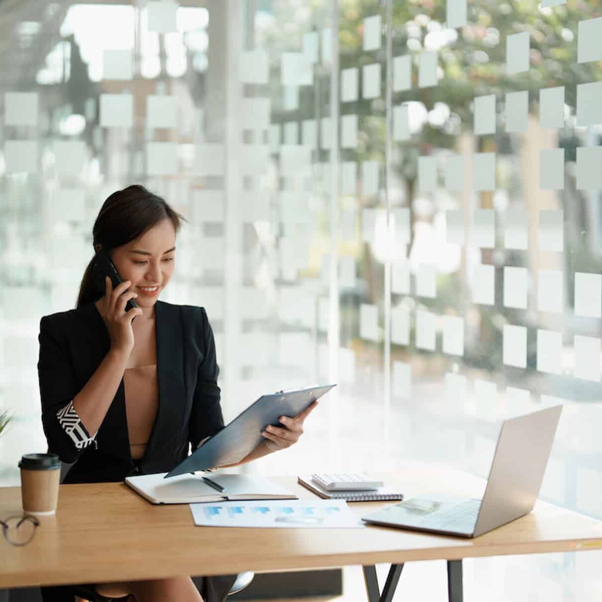 Young accountant marketing call consultants and using laptop computer to analyze sales growth in the global workplace market. time money savings