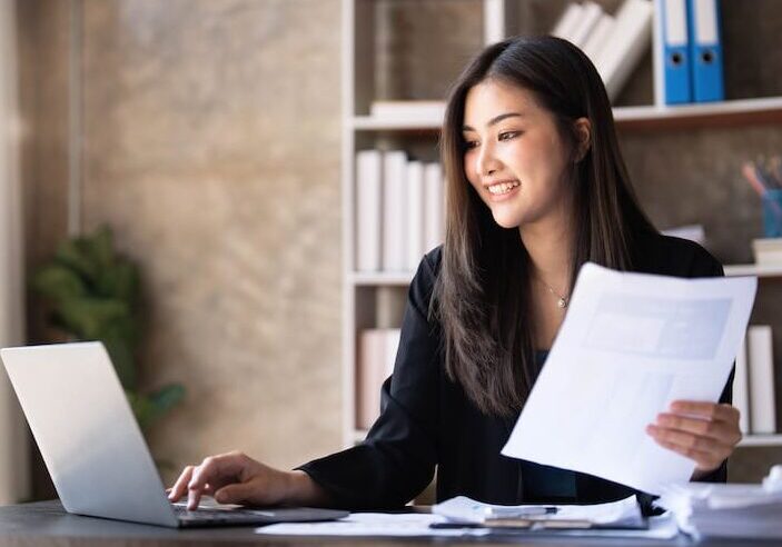 Business woman using calculator for do math finance on wooden desk in office and business working background, tax, accounting, statistics and analytic research concept...