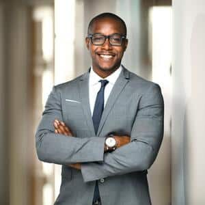 Handsome cheerful african american man, property owner and operator smiling at multifamily property