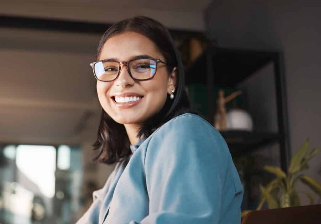 computer and portrait of woman in office at night, property manager