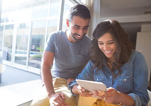 Couple using tablettablet, people, man, young, couple, woman, happy, lifestyle, business, computer, digital, technology, using, caucasian, smiling, coffee, adult, beautiful, together, internet, wireless, sitting, pc, love, cafe, home, hispanic, latin, meeting, corporate, fashion, demim, trendy, blue, yellow, two, office, reading, asian, american, flare, sun, design, creative, girl, boy, window, casualFashion couple using a tablet with sunbeams and lens flare