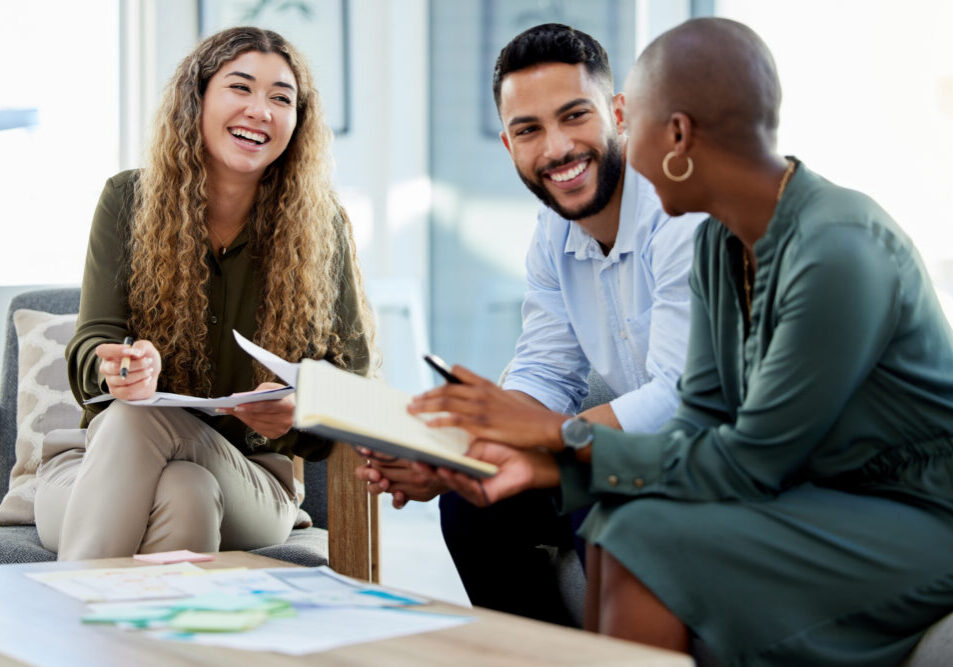 Happy business people smile during a planning meeting in a startup marketing agency office. Diversity, collaboration and teamwork in a healthy work environment in an international advertising company.